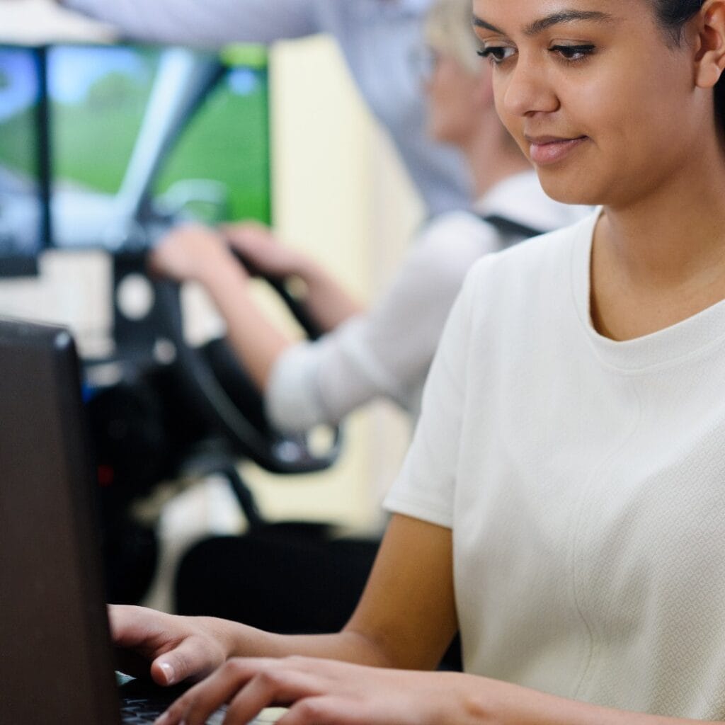 female student doing driving test on computer